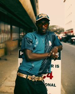 A vibrant and stylish portrait capturing contemporary Ghanaian street fashion in Accra.
