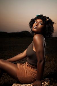 Captivating portrait of a woman outdoors during sunset, highlighting natural beauty and warm tones.